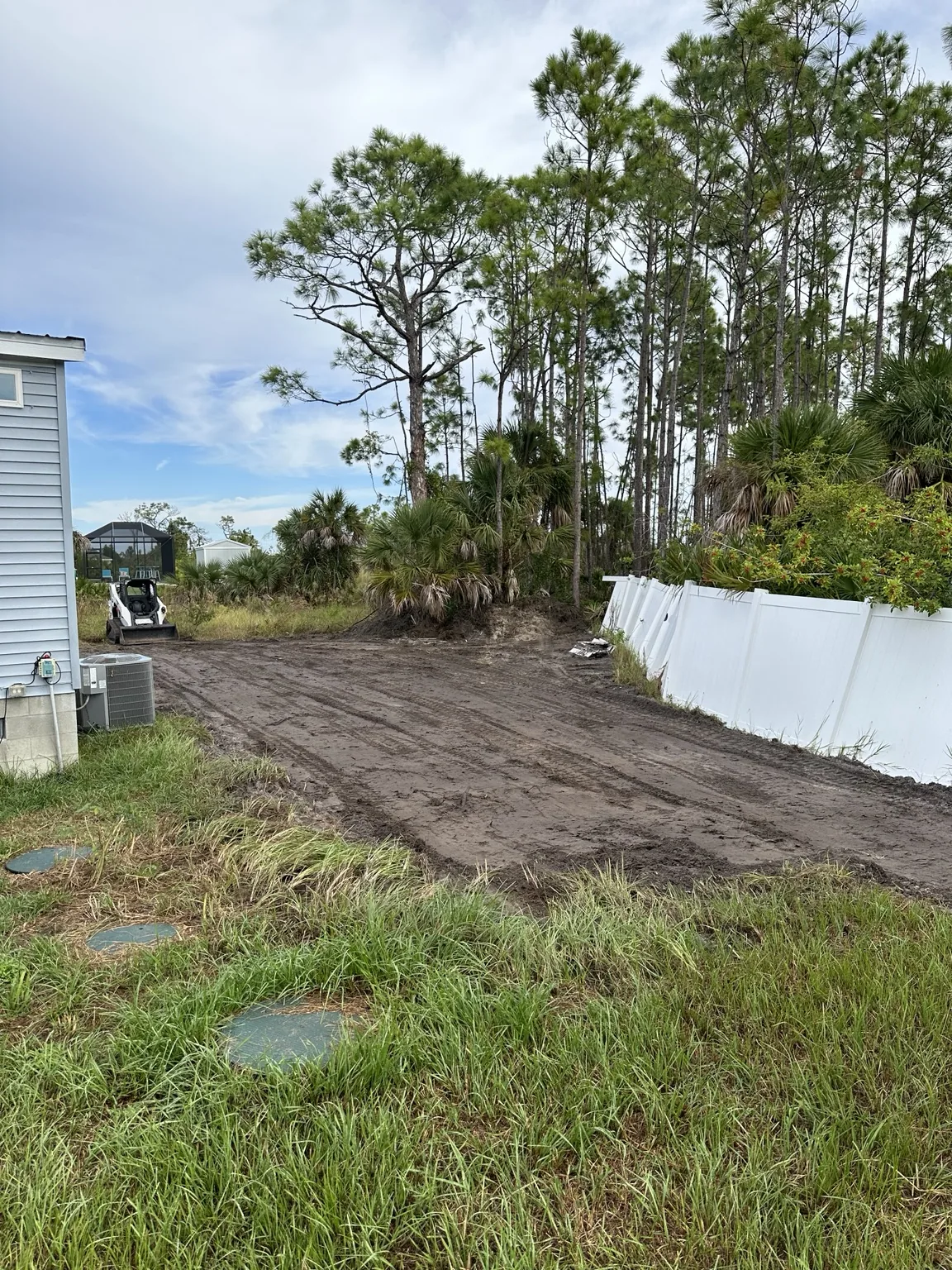 Cleared residential lot area with compact equipment